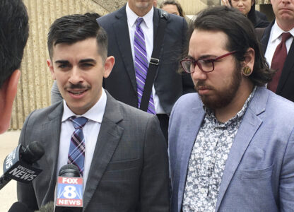 FILE - ACLU lawyer Chase Strangio, left, and plaintiff Joaquin Carcano address reporters after a hearing, June 25, 2018, in Winston-Salem, N.C., on their lawsuit challenging the law that replaced North Carolina's 