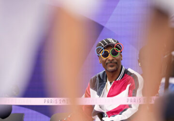 FILE - American artist Snoop Dogg sits in the audience prior to the breaking competition at La Concorde Urban Park at the 2024 Summer Olympics, Friday, Aug. 9, 2024, in Paris, France. (AP Photo/Frank Franklin, File)