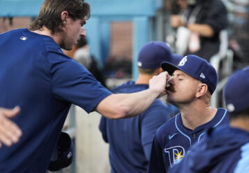 FILE - Tampa Bay Rays' Ryan Pepiot, left, adjusts the mustache of starting pitcher Tyler Alexander before a baseball game against the Los Angeles Dodgers in Los Angeles, Friday, Aug. 23, 2024. (AP Photo/Ashley Landis, File)