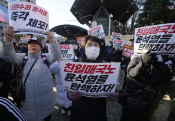 Members of main opposition Democratic Party stage a rally against South Korean President Yoon Suk Yeol in front of the National Assembly in Seoul, South Korea, Wednesday, Dec. 4, 2024. The signs read 