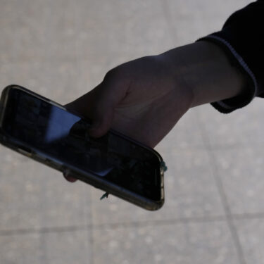 A teenage girl uses her phone in Sydney, Friday, Nov. 8, 2024. (AP Photo/Rick Rycroft)
