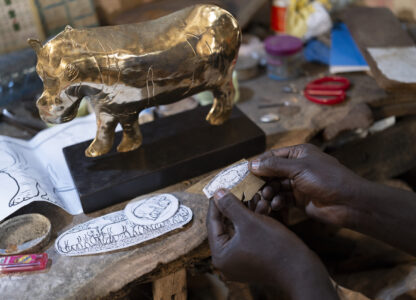 Jeweller Moussa Diop works on a bronze hippopotamus in his workshop, as part of the rebondir exhibition at the Dakar 2024 biennial Off in Dakar, Senegal, Thursday, Nov. 28, 2024. (AP Photo/Sylvain Cherkaoui)