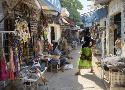 A woman walks through the Soubedioune craft market in Dakar, Senegal, Thursday, Nov. 28, 2024. (AP Photo/Sylvain Cherkaoui)