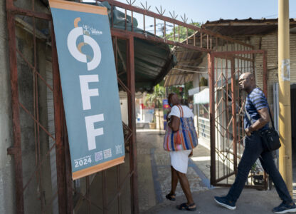 People enterthe Soumbedioune craft market in Dakar, Senegal, Thursday, Nov. 28, 2024. (AP Photo/Sylvain Cherkaoui)