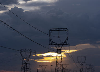As the sun rises behind powerlines on Thursday, Aug. 22, 2024, in Boardman, Ore. (AP Photo/Jenny Kane)