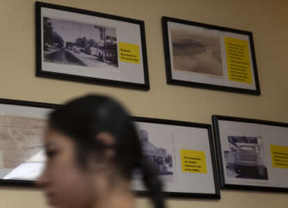 A waitress walks past historical images of Boardman, Ore., at Sunrise At Boardman cafe on Friday, Aug. 23, 2024, in Boardman. (AP Photo/Jenny Kane)