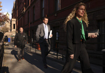 New York Police investigators exit the HI New York City Hostel, Thursday, Dec. 5, 2024, in New York, where police say the suspect in the killing of UnitedHealthcare CEO Brian Thompson may have stayed. (AP Photo/Yuki Iwamura)