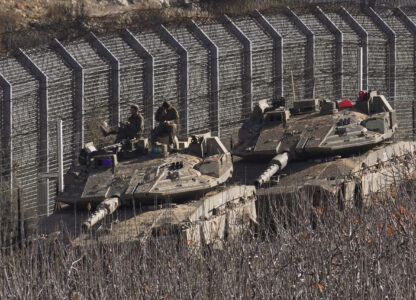 Israeli soldiers sit on top of a tank along the so-called Alpha Line that separates the Israeli-annexed Golan Heights from Syria, in the town of Majdal Shams, Monday, Dec. 9, 2024. (AP Photo/Matias Delacroix)