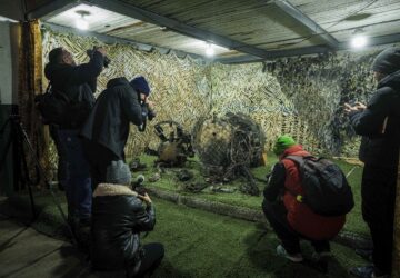 FILE - Journalists at a center for forensic analysis in undisclosed location in Ukraine on Nov. 24, 2024, film fragments of what authorities in Kyiv described as a Russian hypersonic missile that struck a factory in Dnipro, Ukraine, on Nov. 21. (AP Photo/Evgeniy Maloletka, File)