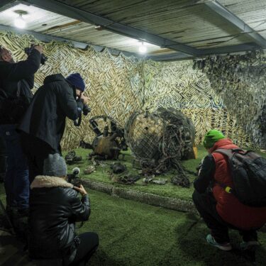 FILE - Journalists at a center for forensic analysis in undisclosed location in Ukraine on Nov. 24, 2024, film fragments of what authorities in Kyiv described as a Russian hypersonic missile that struck a factory in Dnipro, Ukraine, on Nov. 21. (AP Photo/Evgeniy Maloletka, File)