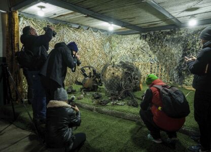 FILE - Journalists at a center for forensic analysis in undisclosed location in Ukraine on Nov. 24, 2024, film fragments of what authorities in Kyiv described as a Russian hypersonic missile that struck a factory in Dnipro, Ukraine, on Nov. 21. (AP Photo/Evgeniy Maloletka, File)