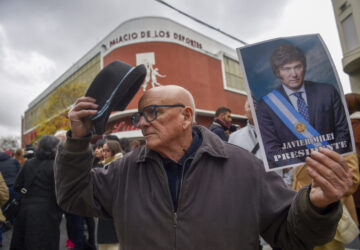 FILE - Supporters of Argentine President Javier Milei arrive at a stadium for the presentation of his book titled 