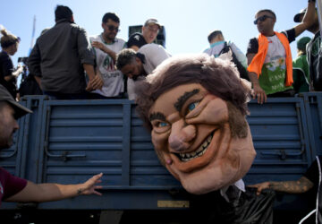 FILE - A demonstrator holds a giant doll depicting President Javier Milei during a protest demanding the reincorporation of state workers laid off as part of state economic downsizing measures in Buenos Aires, Argentina, April 5, 2024. (AP Photo/Natacha Pisarenko, File)