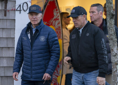 President Joe Biden and son Hunter Biden walk in downtown Nantucket Mass., Friday, Nov. 29, 2024. (AP Photo/Jose Luis Magana)