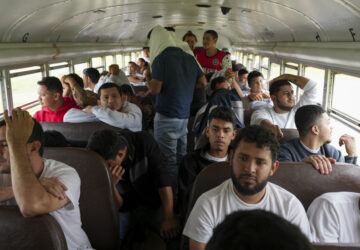 Honduran migrants who were deported from the U.S. sit on a bus after deplaning at Ramon Villeda Morales Airport in San Pedro Sula, Honduras, Wednesday, Dec. 4, 2024. (AP Photo/Moises Castillo)