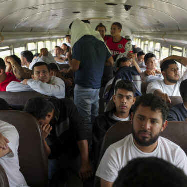 Honduran migrants who were deported from the U.S. sit on a bus after deplaning at Ramon Villeda Morales Airport in San Pedro Sula, Honduras, Wednesday, Dec. 4, 2024. (AP Photo/Moises Castillo)
