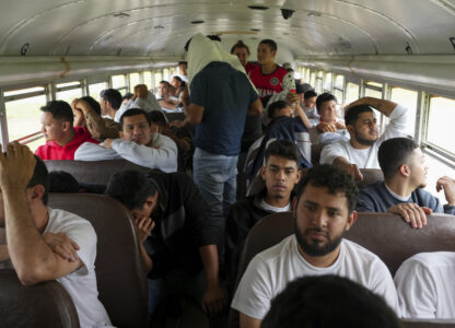 Honduran migrants who were deported from the U.S. sit on a bus after deplaning at Ramon Villeda Morales Airport in San Pedro Sula, Honduras, Wednesday, Dec. 4, 2024. (AP Photo/Moises Castillo)