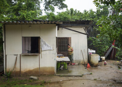 Larissa Martinez, who was deported from the U.S. in 2021 with her three children, looks at her phone at her home on the outskirts of San Pedro Sula, Honduras, Wednesday, Dec. 4, 2024. (AP Photo/Moises Castillo)