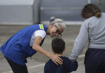 Idalina Bordignon, a nun with Scalabrinian Missionaries, greets a Honduran migrant who was deported from the U.S., at Ramon Villeda Morales Airport, in San Pedro Sula, Honduras, Wednesday, Dec. 4, 2024. (AP Photo/Moises Castillo)