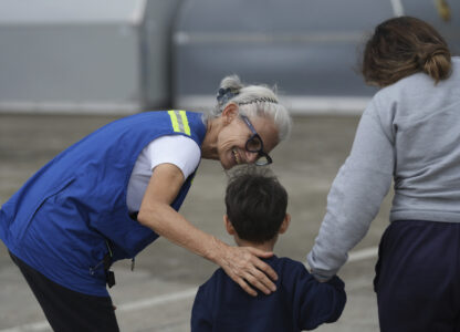 Idalina Bordignon, a nun with Scalabrinian Missionaries, greets a Honduran migrant who was deported from the U.S., at Ramon Villeda Morales Airport, in San Pedro Sula, Honduras, Wednesday, Dec. 4, 2024. (AP Photo/Moises Castillo)