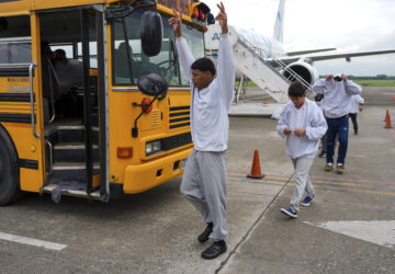 A Honduran migrant celebrates upon arriving at Ramon Villeda Morales Airport in San Pedro Sula, Honduras, after being deported from the U.S., Wednesday, Dec. 4, 2024. (AP Photo/Moises Castillo)