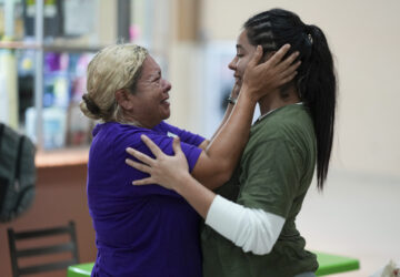 Honduran migrant Kimberly Orellana, right, greets her mother Oralia Mejía after being deported from the U.S., at a bus station in San Pedro Sula, Honduras, Wednesday, Dec. 4, 2024. (AP Photo/Moises Castillo)
