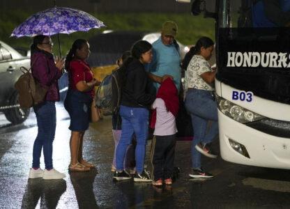 People, mostly Honduran migrants, get on a bus in the hope of reaching the U.S., in San Pedro Sula, Honduras, Tuesday, Dec. 3, 2024. (AP Photo/Moises Castillo)