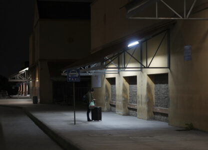A woman waits for a bus at a station in San Pedro Sula, Honduras, Tuesday, Dec. 3, 2024. (AP Photo/Moises Castillo)