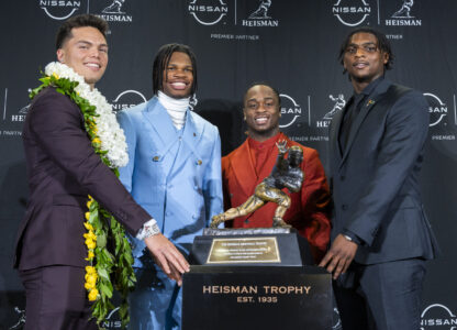 Heisman Trophy finalists, from left, Oregon's Dillon Gabriel, Colorado's Travis Hunter, Boise State's Ashton Jeanty and Miami's Cam Ward pose with the trophy during a college football press conference, Saturday, Dec. 14, 2024, in New York. (AP Photo/Corey Sipkin)