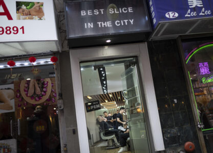 Barbers work on their clients at 12 Pell, a local barbershop in Manhattan's Chinatown, Thursday, Jan. 25, 2024, in New York. (AP Photo/John Minchillo)