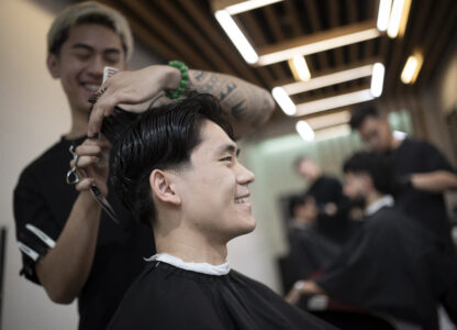 Barbers work on their clients at 12 Pell, a local barbershop in Manhattan's Chinatown, Thursday, Jan. 25, 2024, in New York. (AP Photo/John Minchillo)