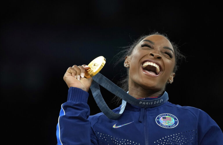 FILE - Simone Biles, of the United States, celebrates after winning the gold medal at the medal ceremony during the women's artistic gymnastics individual vault finals at Bercy Arena at the 2024 Summer Olympics, Saturday, Aug. 3, 2024, in Paris, France. (AP Photo/Francisco Seco, File)