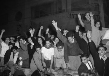FILE - Jewish people wave and cheer as they gather in the streets of Tel Aviv after radio broadcasts announce that the United Nations plans for the partition of Palestine and the new Jewish state, Nov. 30, 1947. (AP Photo/Jim Pringle, File)