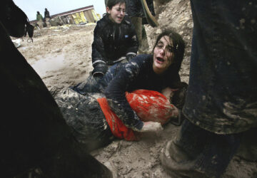 FILE - Israeli settler girls cry in the mud after being dragged away by Israeli army soldiers dismantling an illegal structure at an outpost outside the Jewish settlement of Yitzhar, near the West Bank town of Nablus, Jan. 3, 2005. (AP Photo/Kevin Frayer, File)