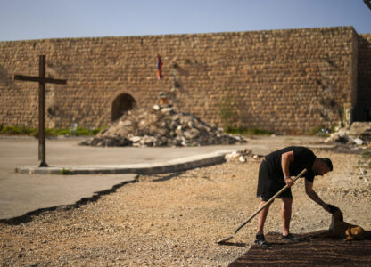 An Armenian activist pets a dog in a parking area known by locals as 