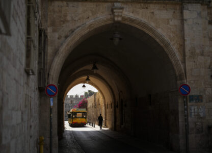 An Israeli ultra-orthodox walks through a narrow limestone passageway at the Armenian quarter in Jerusalem, Thursday, Nov. 21, 2024. (AP Photo/Francisco Seco)