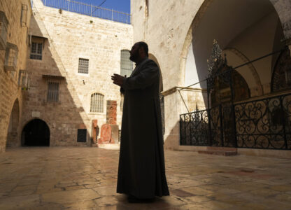 Chancellor of the Armenian Patriarchate of Jerusalem Father Aghan Gogchyan gestures outside St. James Cathedral at the Armenian quarter in Jerusalem, Thursday, Nov. 21, 2024. (AP Photo/Francisco Seco)