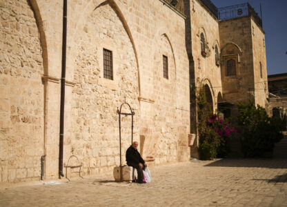 An Armenian resident sits at the main square of the Armenian quarter in Jerusalem, Thursday, Nov. 21, 2024. (AP Photo/Francisco Seco)