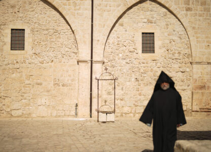 An Armenian Christian priest walks along the main square of the Armenian quarter in Jerusalem, Thursday, Nov. 21, 2024. (AP Photo/Francisco Seco)