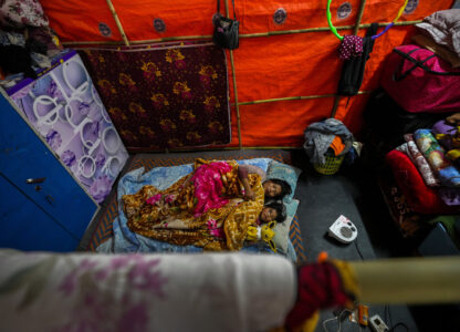 A Kuki tribal woman and her daughter rest in a relief camp in Kangpokpi, Manipur, Sunday, Dec. 15, 2024. (AP Photo/Anupam Nath)