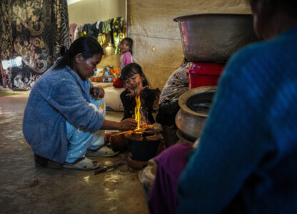 A Kuki tribal woman lights fire to prepare food in a relief camp in Kangpokpi, Manipur, Sunday, Dec. 15, 2024. (AP Photo/Anupam Nath)