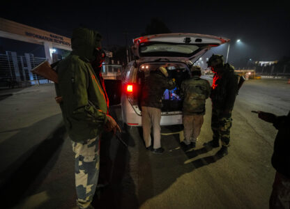 Security personnel check vehicles in Imphal, Manipur, Sunday, Dec. 15, 2024. (AP Photo/Anupam Nath)