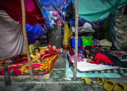 A Meitei woman and children take rest in a relief camp in Imphal, Manipur, Monday, Dec. 16, 2024. (AP Photo/Anupam Nath)