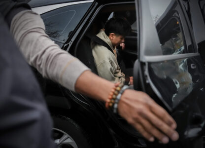 A deportation officer with Enforcement and Removal Operations in U.S. Immigration and Customs Enforcement's New York City field office puts Wilmer Patricio Medina-Medina in the back of a car after arresting him during an early morning operation, Tuesday, Dec. 17, 2024, in the Bronx borough of New York. (AP Photo/Julia Demaree Nikhinson)