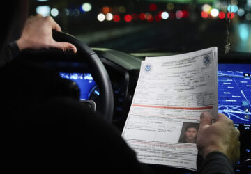 Kenneth Genalo, director of U.S. Immigration and Customs Enforcement's New York City field office, holds an information sheet on Wilmer Patricio Medina-Medina during an early morning operation, Tuesday, Dec. 17, 2024, in the Bronx borough of New York. (AP Photo/Julia Demaree Nikhinson)