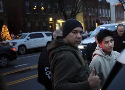 Deportation officers with Enforcement and Removal Operations in U.S. Immigration and Customs Enforcement's New York City field office arrest Wilmer Patricio Medina-Medina during an early morning operation, Tuesday, Dec. 17, 2024, in the Bronx borough of New York. (AP Photo/Julia Demaree Nikhinson)