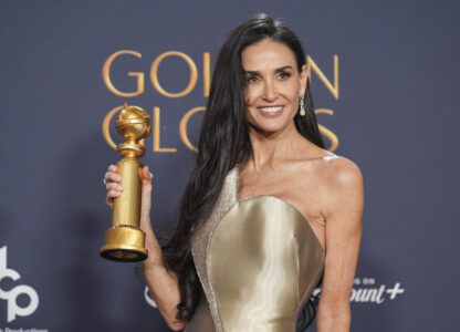 Demi Moore poses in the press room with the award for best performance by a female actor in a motion picture - musical or comedy for 