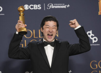 Tadanobu Asano poses in the press room with the award for best performance by a male actor in a supporting role on television for 