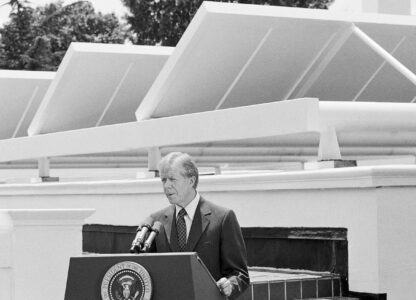 FILE - President Jimmy Carter speaks against a backdrop of solar panels at the White House, June 21, 1979, in Washington. (AP Photo/Harvey Georges, File)
