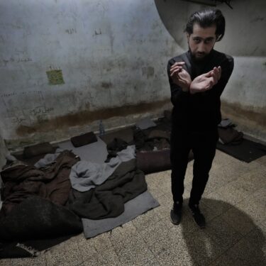 Abdullah Zahra demonstrates how he was tortured in a cell at Branch 215, a detention facility run by military intelligence during Bashar Assad's regime, in Damascus, Syria, on Tuesday, Dec. 17, 2024. (AP Photo/Hussein Malla)